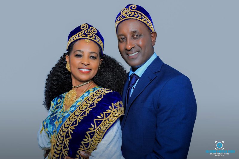 Couple standing together in embroidered formal attire